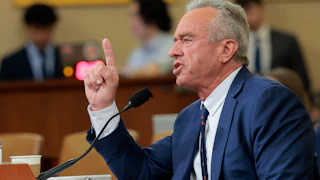 Health Secretary Robert F. Kennedy Jr. raises a finger while speaking into a microphone during a House committee hearing