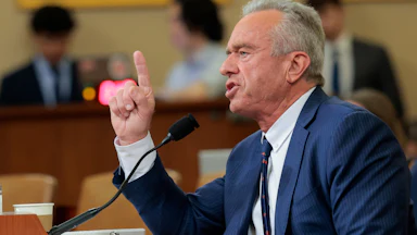 Health Secretary Robert F. Kennedy Jr. raises a finger while speaking into a microphone during a House committee hearing