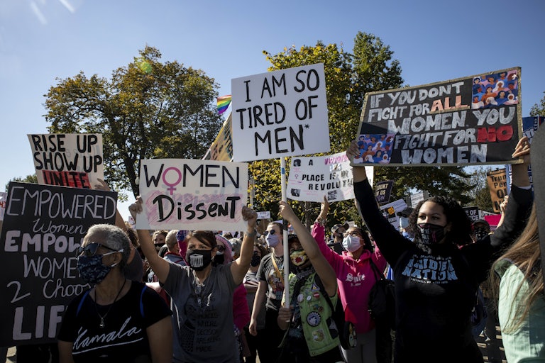 People hold up pro-abortion protest signs