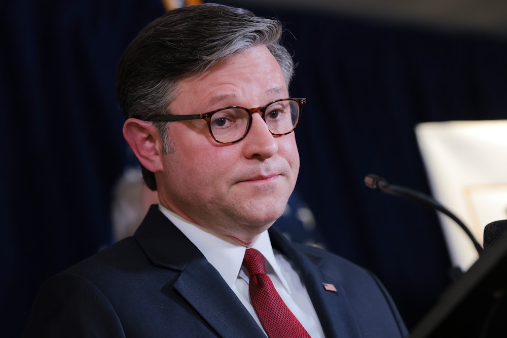 House Speaker Mike Johnson stands in a press conference