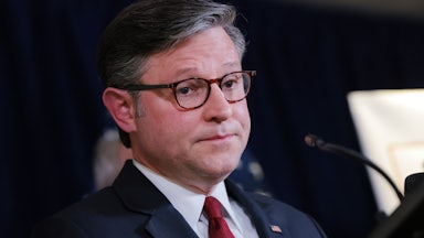 House Speaker Mike Johnson stands in a press conference