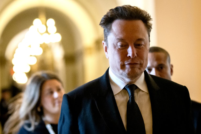 Elon Musk walks in Congress