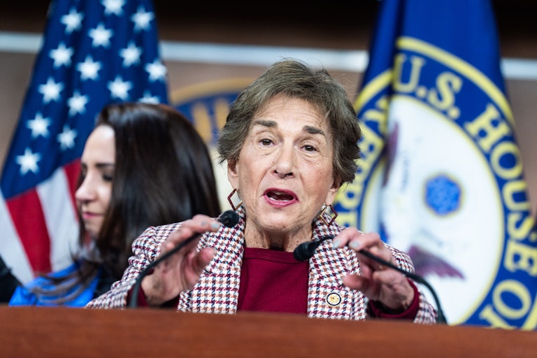 Representative Jan Schakowsky gestures while speaking at a podium during a press conference