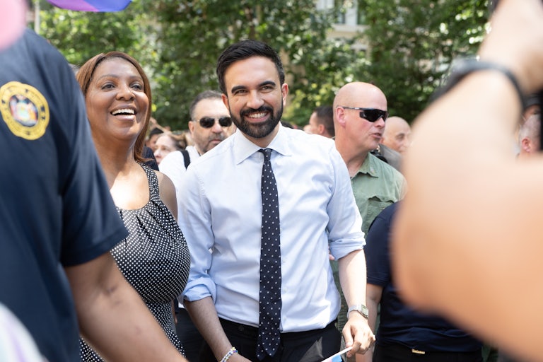New York City Democratic mayoral candidate Zohran Mamdani smiles while walking with New York Attorney General Letitia James in the New York City Pride parade