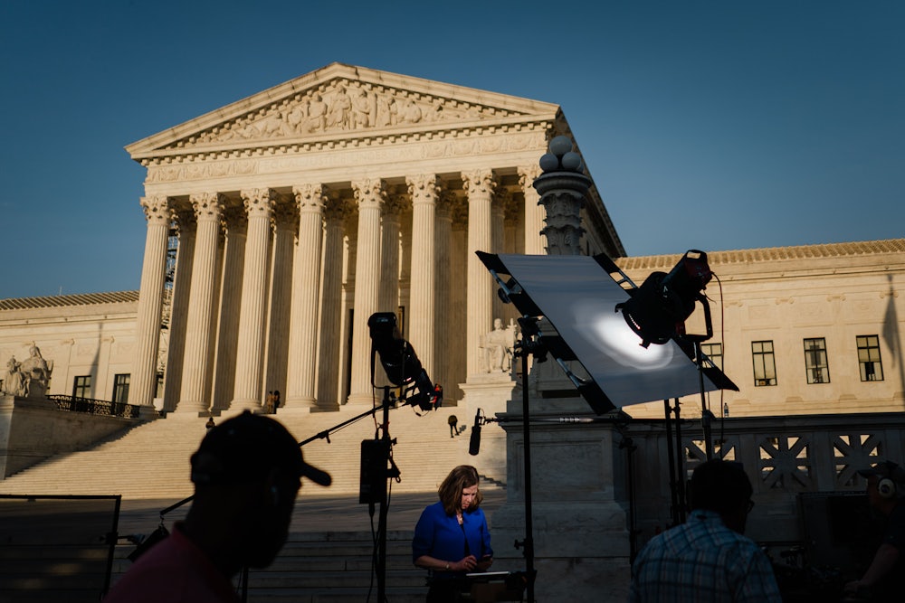 Television crews set up in front of the Supreme Court building.