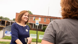 Ghazala Hashmi smiles and speaks to a voter