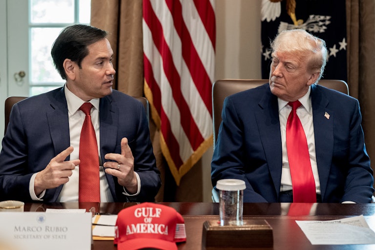 Secretary of State Marco Rubio and Donald Trump look at each other during a Cabinet meeting