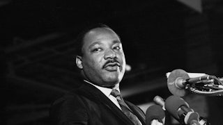 The Reverend Martin Luther King Jr. standing in front of a microphone