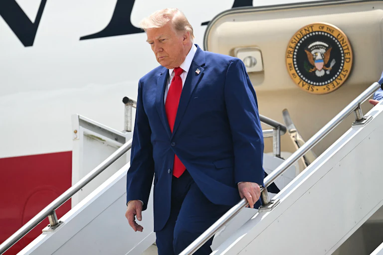 Donald Trump walks down the steps of Air Force One.