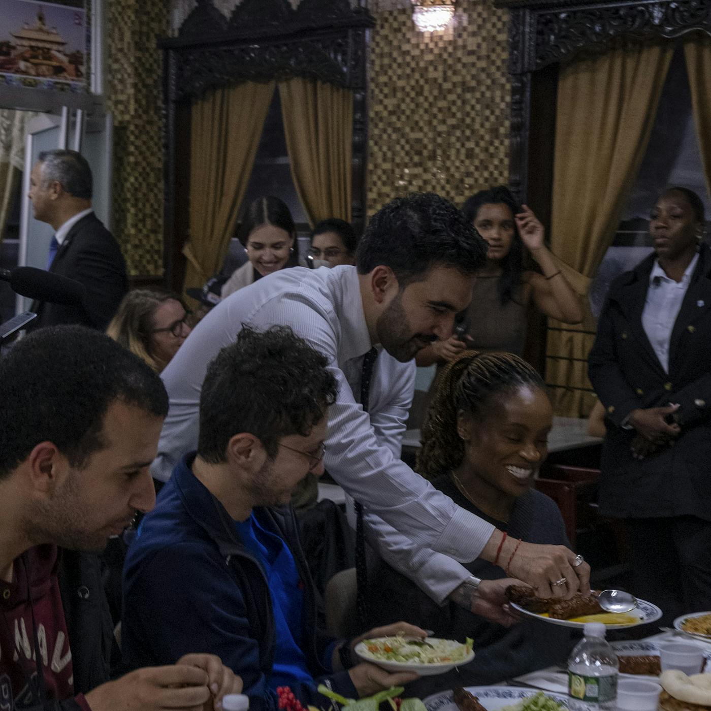 Zohran Mamdani serves food to cab drivers and patrons at Al-Rahma Restaurant in Astoria 