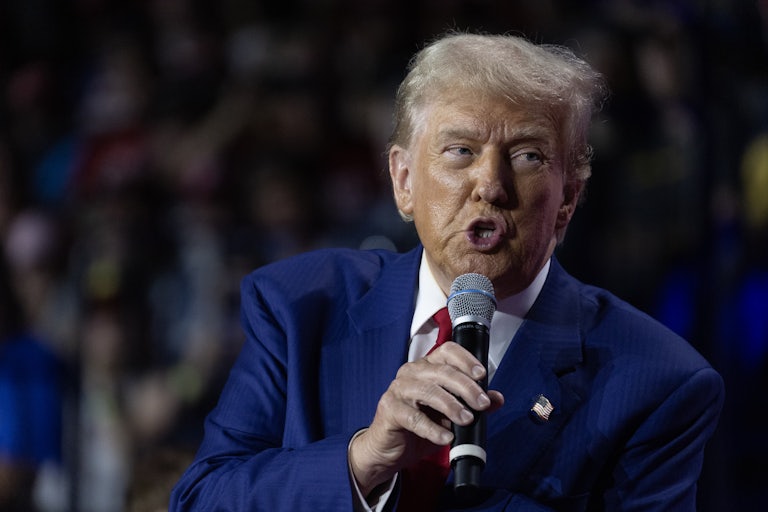 Donald Trump speaks into a mic