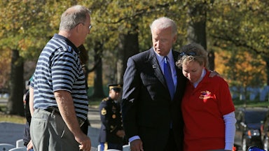 Joe Biden stands with David Smith’s parents in Arlington Cemetery.