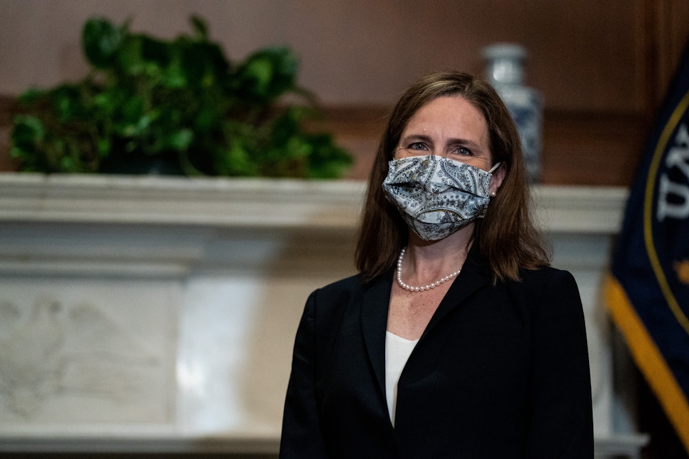 Justice Amy Coney Barrett sits for a meeting on Capitol Hill.