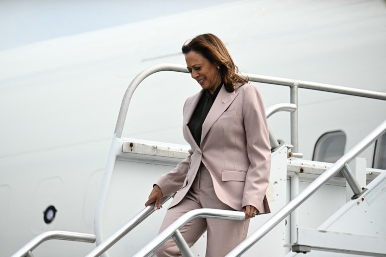 Kamala Harris looks down while disembarking from Air Force Two