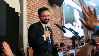 New York City mayoral candidate Zohran Mamdani smiles and puts his hand on his chest during his victory speech