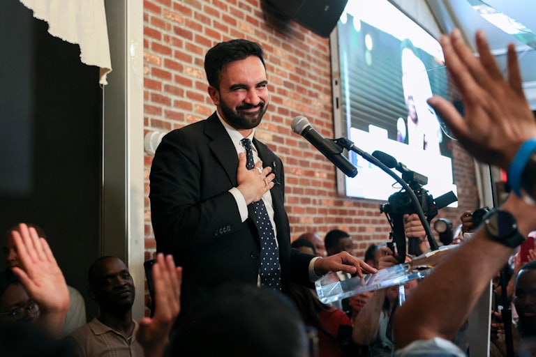 New York City mayoral candidate Zohran Mamdani smiles and puts his hand on his chest during his victory speech