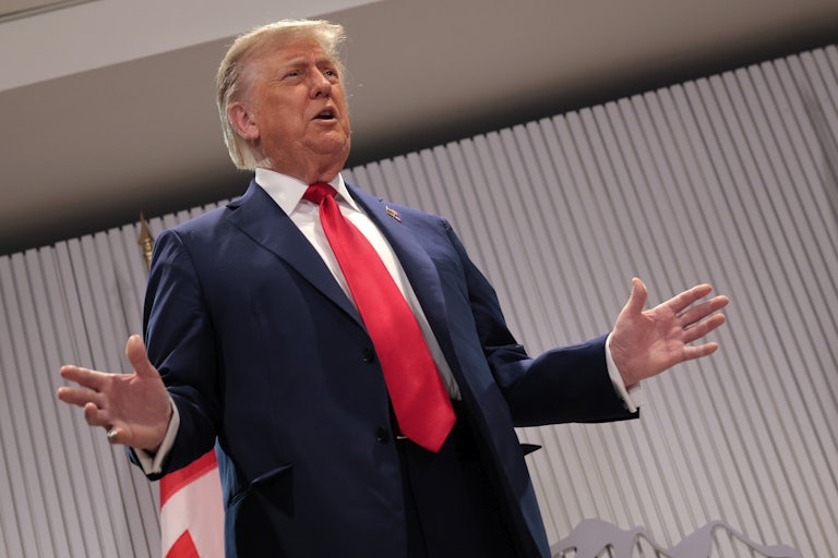 Donald Trump gestures while speaking at the G7 summit in Canada