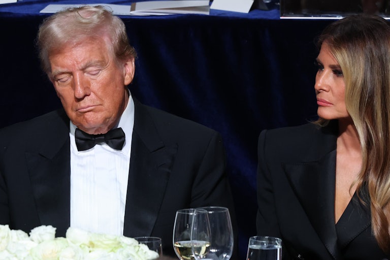 Donald Trump sits with his eyes closed while Melania Trump sits next to him