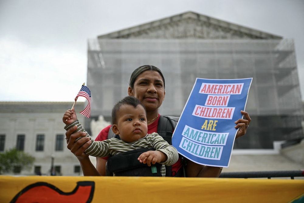 Olga Urbina and her son Ares Webster participate in a protest outside the US Supreme Court over President Donald Trump’s move to end birthright citizenship.