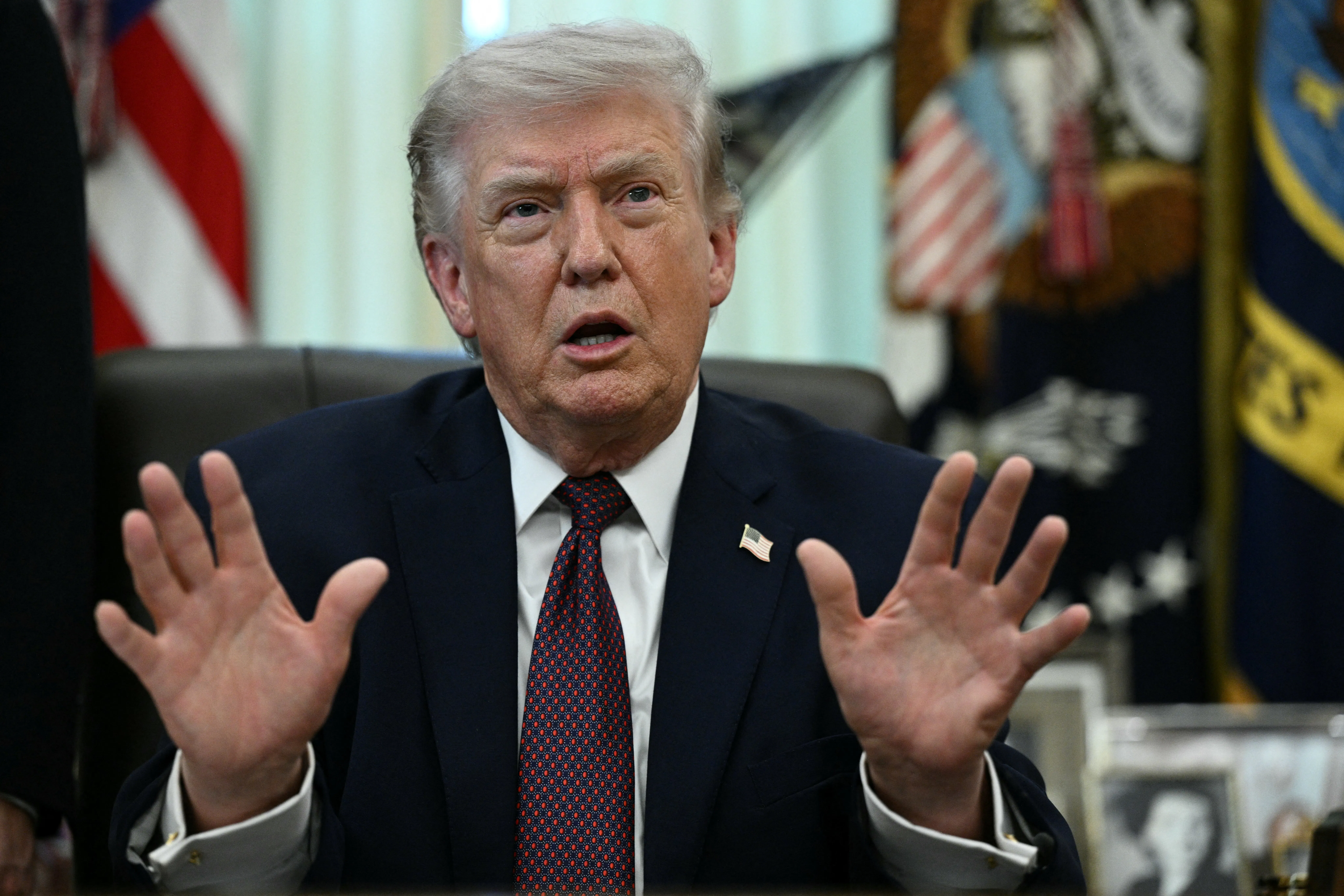 Donald Trump at his desk in the Oval Office.