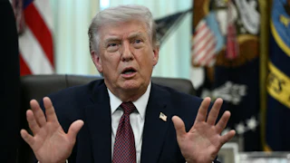 Donald Trump at his desk in the Oval Office.