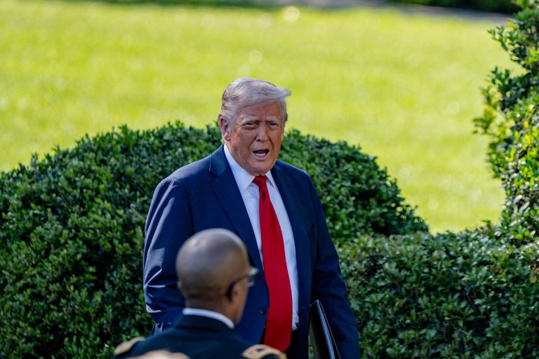 Donald Trump speaks while walking on the White House south lawn