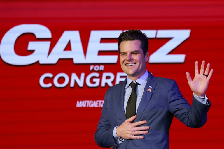 Matt Gaetz smiles, one hand on his chest and one raised in the air as if in greeting. A red sign behind him reads "Gaetz for Congress" in giant letters.
