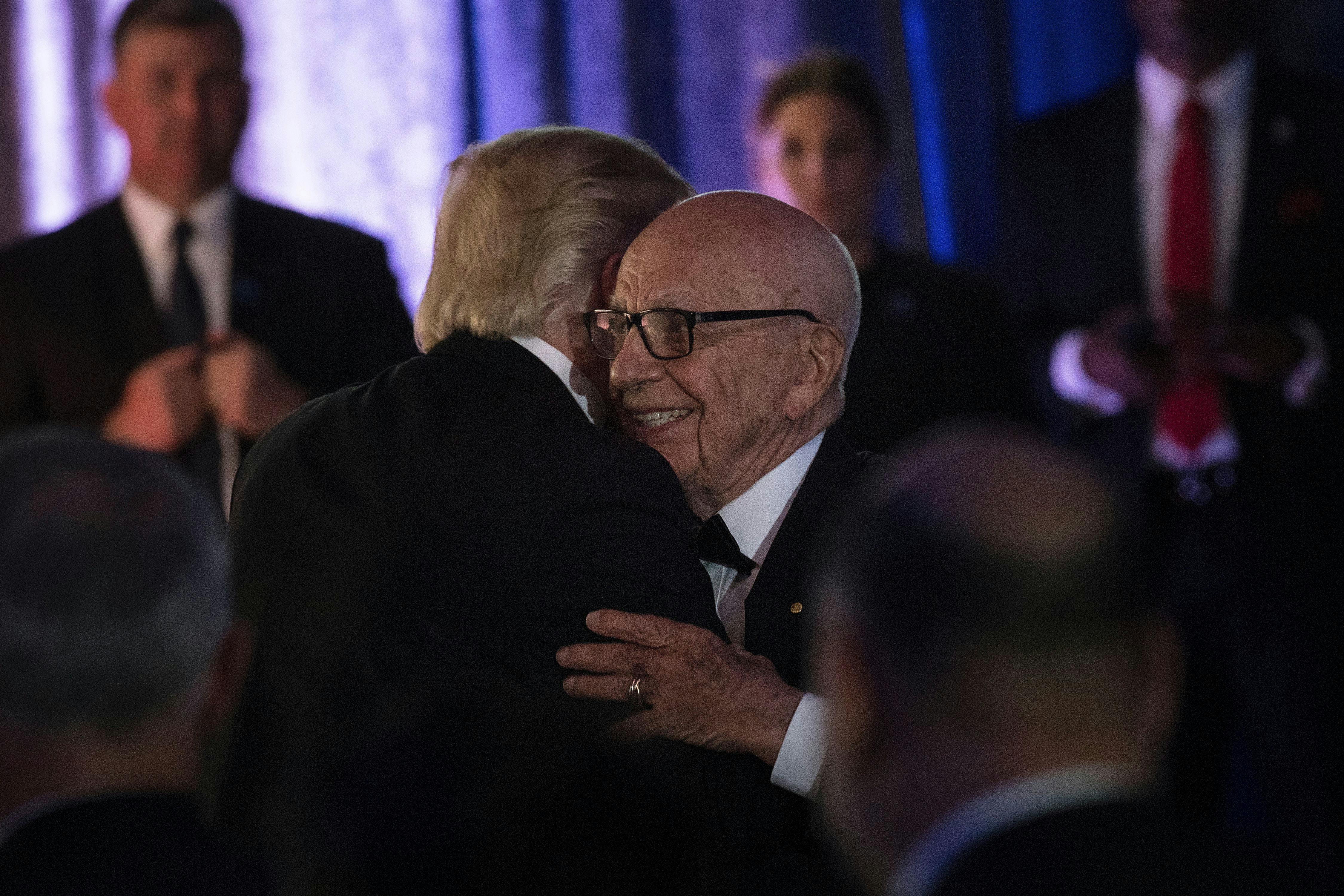 Trump and Rupert Murdoch embrace at a ceremony in New York