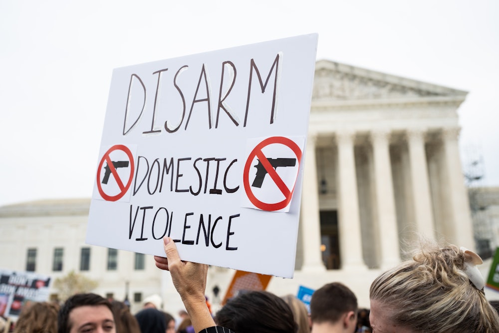 Activists rally outside the Supreme Court before the start of oral arguments in the United States v. Rahimi