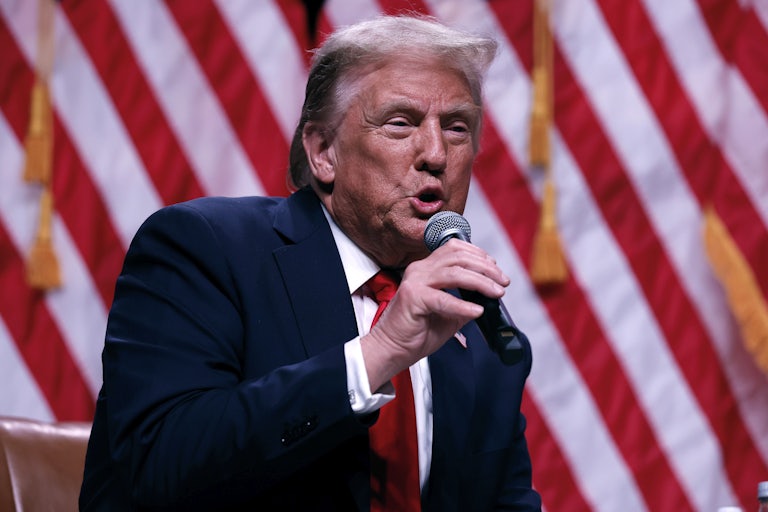 Donald Trump speaks into a handheld microphone