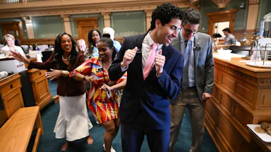 Manny Rutinel, center, and other Colorado representatives dance on the state House floor in 2024