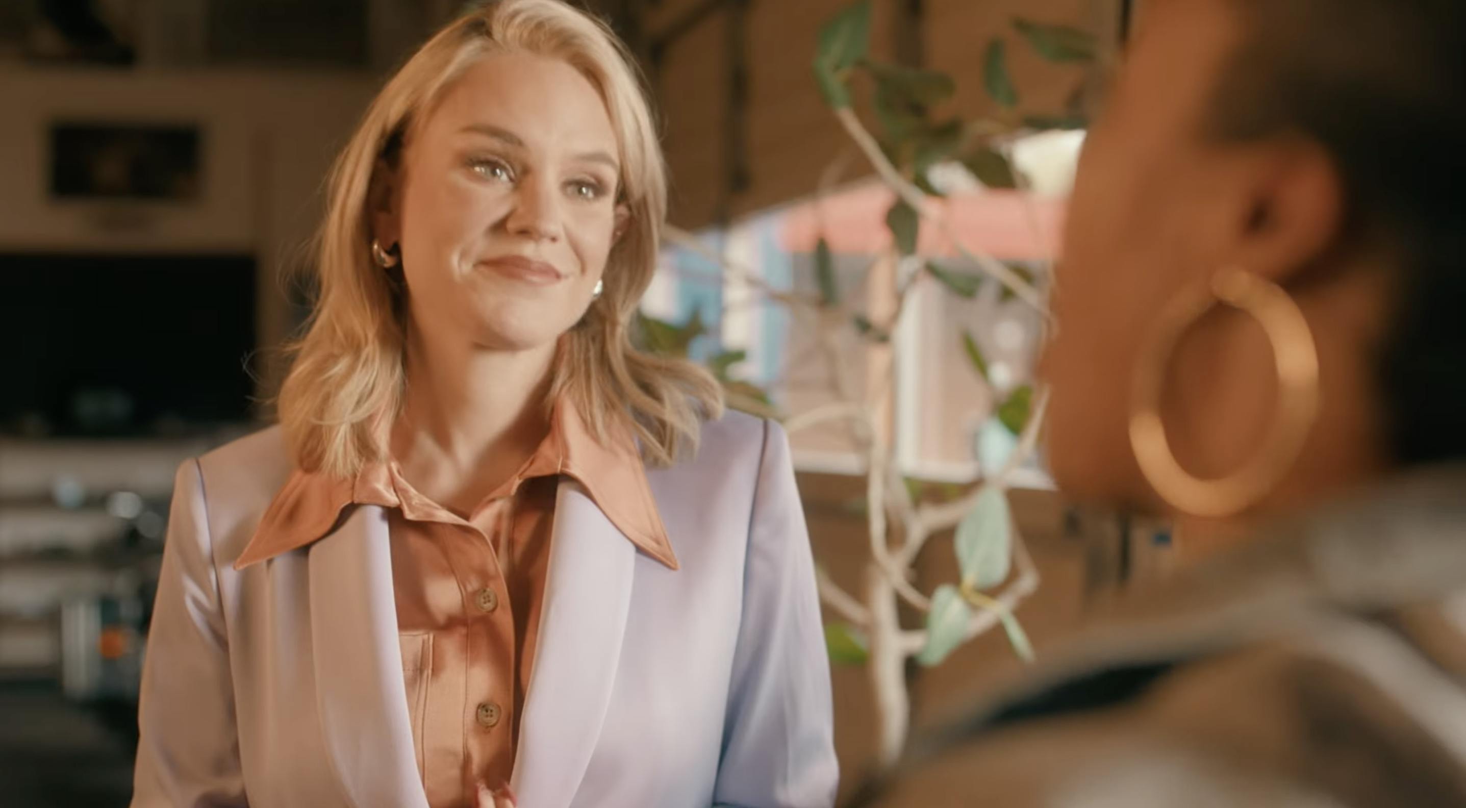 Aftyn Behn smiles as she listens to someone.