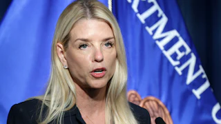 Attorney General Pam Bondi speaks into a microphone during a press conference