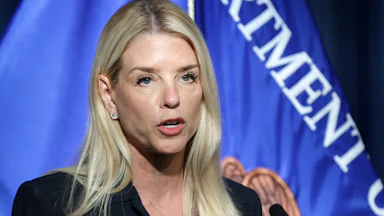 Attorney General Pam Bondi speaks into a microphone during a press conference