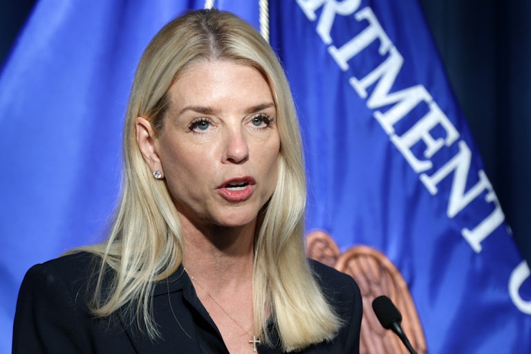 Attorney General Pam Bondi speaks into a microphone during a press conference