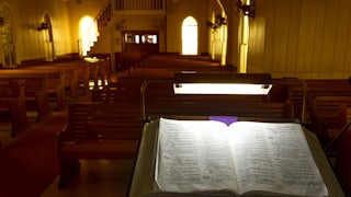 Evening light filters through colored windows at United Evangelical Lutheran Church in Swiss Alp, Texas.