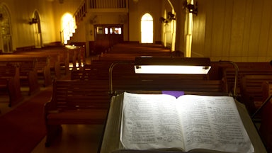 Evening light filters through colored windows at United Evangelical Lutheran Church in Swiss Alp, Texas.
