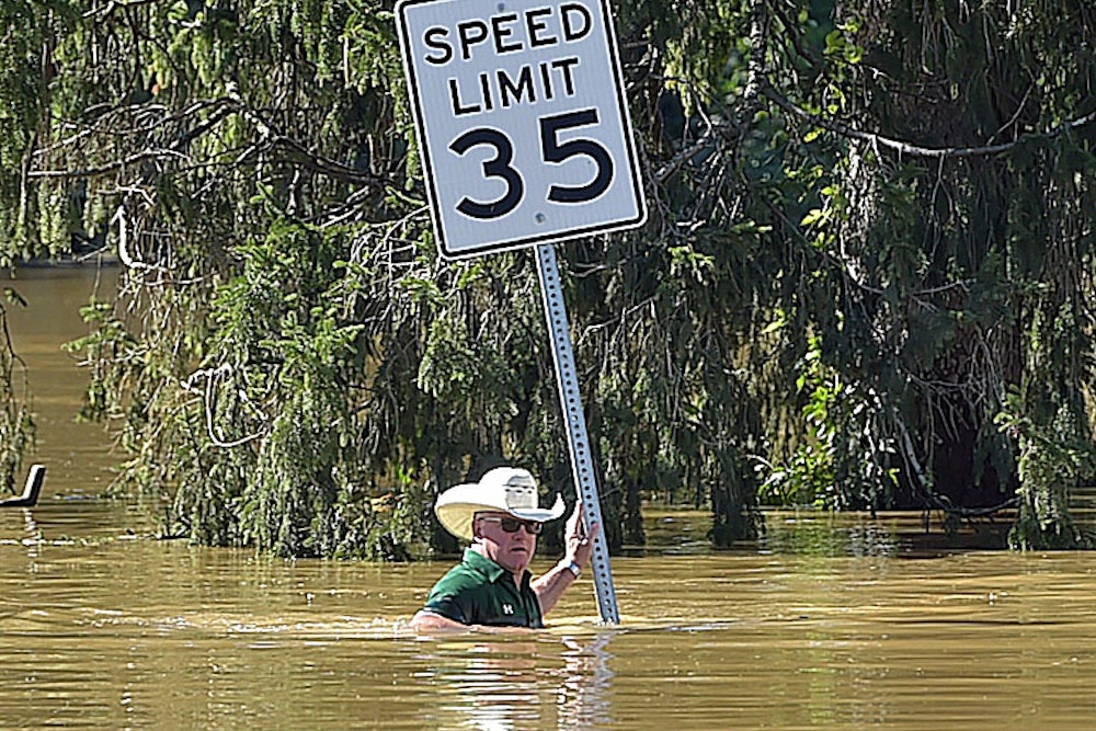 A man stands in water up to his chest.