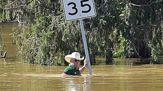 A man stands in water up to his chest.