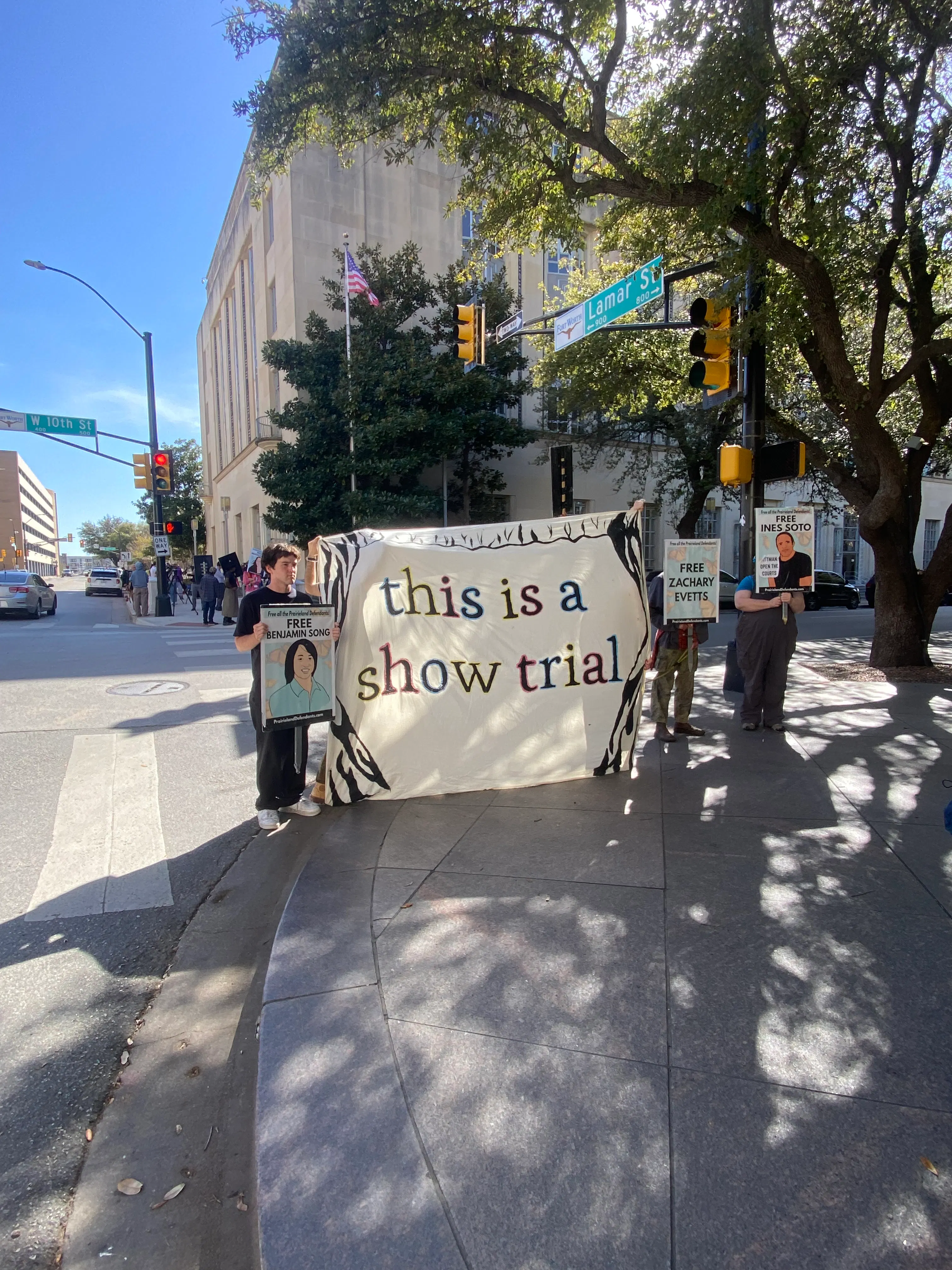 In March, demonstrators outside the Eldon B. Mahon United States Courthouse in Fort Worth, Texas, showed support for defendants in the Prairieland cases. They held a sign saying "This is a show trial." 