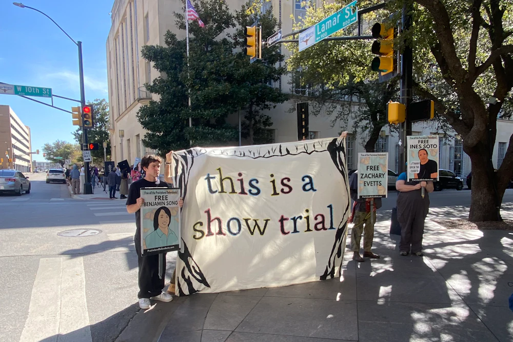 In March, demonstrators outside the Eldon B. Mahon United States Courthouse in Fort Worth, Texas, showed support for defendants in the Prairieland cases. They held a sign saying "This is a show trial."
