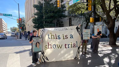 In March, demonstrators outside the Eldon B. Mahon United States Courthouse in Fort Worth, Texas, showed support for defendants in the Prairieland cases. They held a sign saying "This is a show trial."