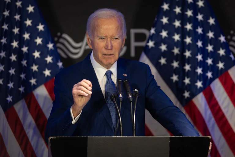 Former President Joe Biden speaks at a podium