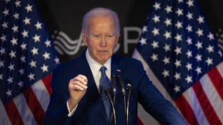 Former President Joe Biden speaks at a podium