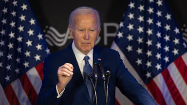 Former President Joe Biden speaks at a podium