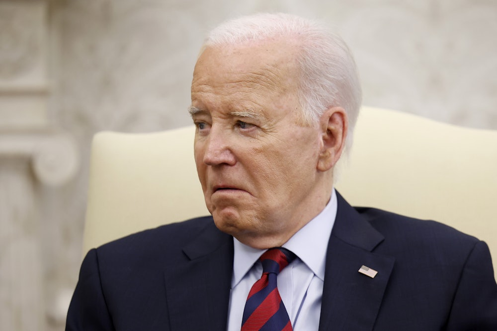 Joe Biden sits in a cream chair and looks very old.