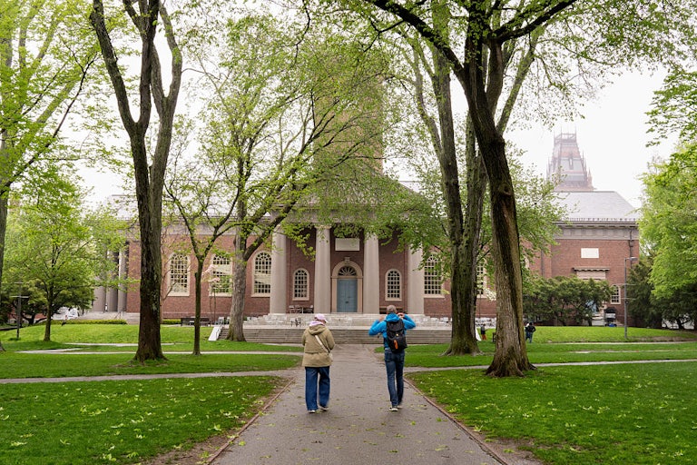 Students walk on Harvard University’s campus.