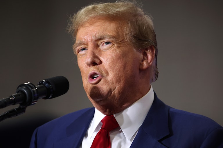 Donald Trump speaks into a microphone
