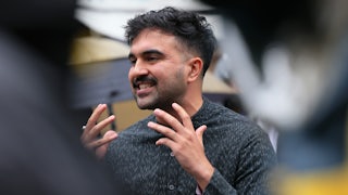 Zohran Mamdani gestures while speaking.