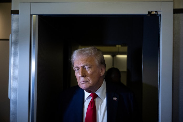 Donald Trump stands with reporters on Air Force One